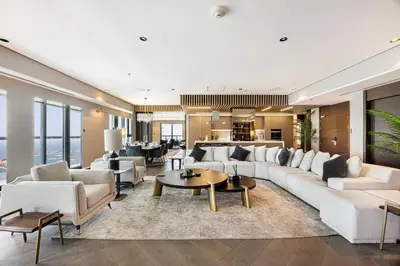 a living room with white couches and tables at Daniels 3BR at Princess Tower With Full Palm Jumeirah View in Dubai