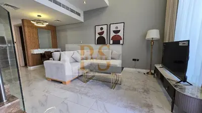 a living room with a couch and a television at 1 bed townhouse in Dubai