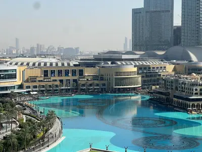 a city with a large pool of blue water at Stunning Burj Khalifa & Fountain Views - Luxury 2BR - 5 minutes walk to Dubai Mall in Dubai