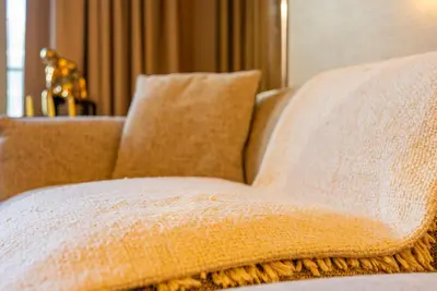 a brown couch with two pillows on it at Stunning Burj Khalifa & Fountain Views - Luxury 2BR - 5 minutes walk to Dubai Mall in Dubai