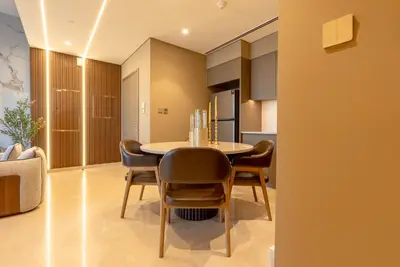 a kitchen and dining room with a table and chairs at Stunning Burj Khalifa & Fountain Views - Luxury 2BR - 5 minutes walk to Dubai Mall in Dubai