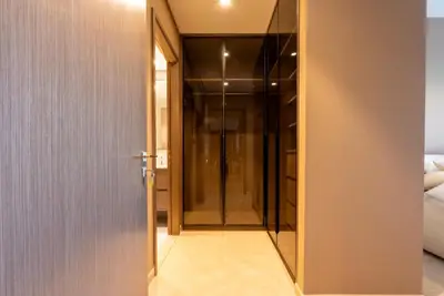 a hallway with a glass door leading to a bedroom at Stunning Burj Khalifa & Fountain Views - Luxury 2BR - 5 minutes walk to Dubai Mall in Dubai
