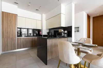 a kitchen with a dining table and chairs at Modern 1Br in the Heart of Dubai by SIMPLY COMFORT in Dubai