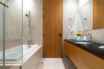 a bathroom with a tub and a sink and a shower at Modern 1Br in the Heart of Dubai by SIMPLY COMFORT in Dubai