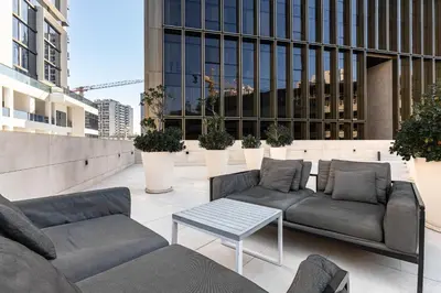 a patio with couches and a table on a building at Modern 1Br in the Heart of Dubai by SIMPLY COMFORT in Dubai