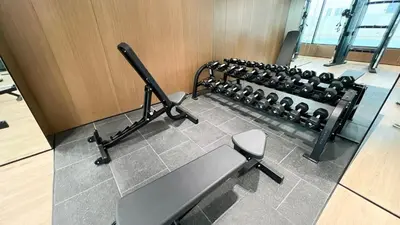 a gym with a row of exercise equipment at Brand New Apt On Top Floor 1BR w Spa And Pool in Dubai