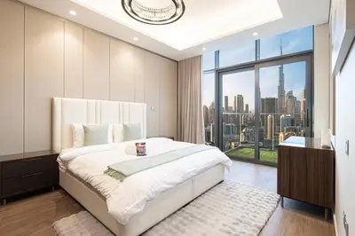 a bedroom with a large bed and a large window at New 1BR APT Business Bay w Burj View in Dubai