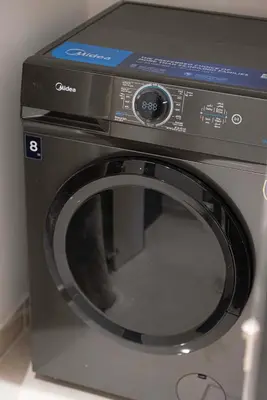 a microwave oven sitting on top of a washing machine at New 1BR APT Business Bay w Burj View in Dubai