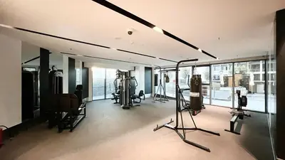 a gym with treadmills and exercise equipment in a room at New 1BR APT Business Bay w Burj View in Dubai
