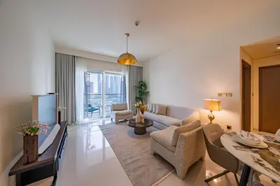 a living room with a couch and a table at Homes Beyond I Seaside 1BR Retreat with Beach Access in Dubai