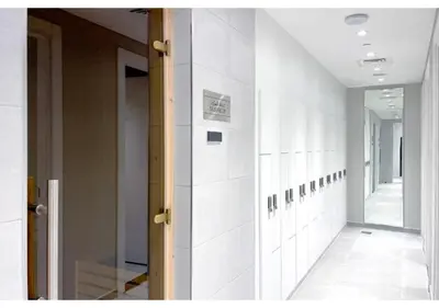 a hallway with white tile walls and a mirror at Keyrock Living - Lakeview Retreat in Business Bay in Dubai