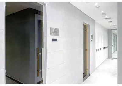 a hallway with white walls and an open door at Exclusive Lakeview Haven - Zada Tower by Keyrock Living in Dubai