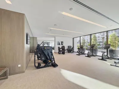 a gym with cardio equipment in a building at 1BR Palace Residences, City View in Dubai