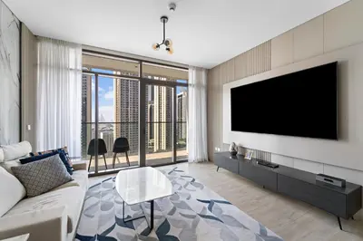 a living room with a flat screen tv on a wall at 1BR Palace Residences, City View in Dubai