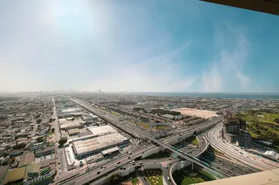 an aerial view of a city with a highway at Modern 3-Bedroom Apartment with Breathtaking City Views in Dubai
