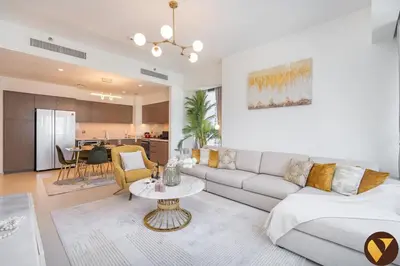 a living room with a couch and a table at Vogue Downtown Act One near Burj Khalifa and Dubai Mall, Two Bedroom Apartment with Balcony and City Skyline View, Access to All Amenities in Dubai