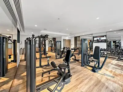 a gym with a lot of treadmills and ellipticals at Vogue Downtown Act One near Burj Khalifa and Dubai Mall, Two Bedroom Apartment with Balcony and City Skyline View, Access to All Amenities in Dubai
