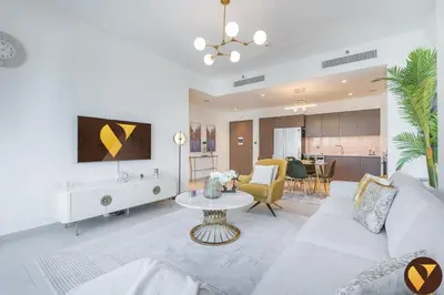 a living room with a couch and a table at Vogue Downtown Act One near Burj Khalifa and Dubai Mall, Two Bedroom Apartment with Balcony and City Skyline View, Access to All Amenities in Dubai