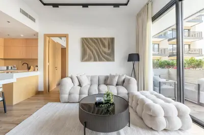 a living room with a white couch and a table at Serene 2BRplus1 Haven in Oakley JVC - 5star Amenities in Dubai