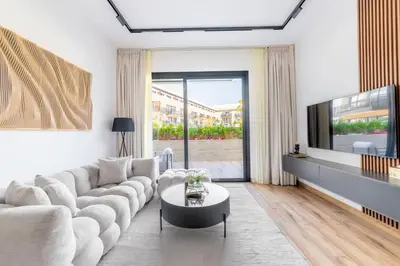 a living room with a couch and a tv at Serene 2BRplus1 Haven in Oakley JVC - 5star Amenities in Dubai