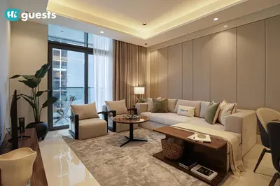 a living room with a couch and a table at HiGuests - Stylish 1BR Retreat with Modern Interiors in Dubai in Dubai