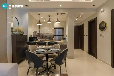a dining room and kitchen with a table and chairs at HiGuests - Stylish 1BR Retreat with Modern Interiors in Dubai in Dubai