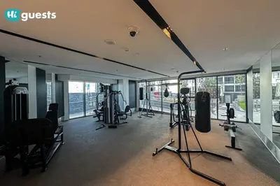 a gym with treadmills and other equipment in a building at HiGuests - Stylish 1BR Retreat with Modern Interiors in Dubai in Dubai