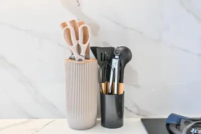 a container filled with utensils on a counter at Pure Voyage JVC in Dubai