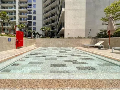 a tile floor with a bench and an umbrella at Keyrock Living - Elegant City Escape at Zada Tower in Dubai