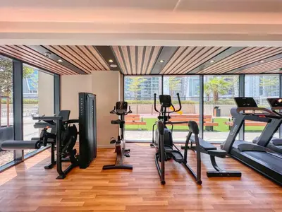 a gym with treadmills and cardio equipment in a building at Keyrock Living - Elegant City Escape at Zada Tower in Dubai