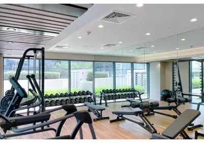a gym with a lot of treadmills and machines at Keyrock Living - Elegant City Escape at Zada Tower in Dubai