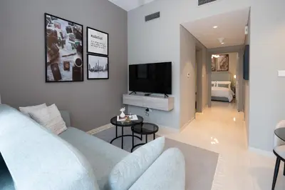 a living room with a couch and a tv at Keyrock Living - Elegant City Escape at Zada Tower in Dubai