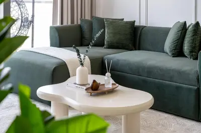 a living room with a couch and a white coffee table at UrbanStays Dubai - Paramount Midtown in Dubai