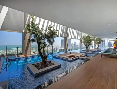 a tree on the floor of a building at UrbanStays Dubai - Paramount Midtown in Dubai