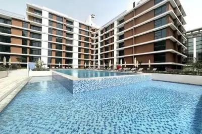 a large swimming pool in front of a building at 016 - Dubai Hills in Dubai