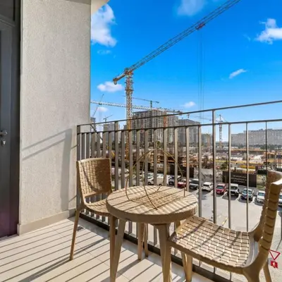 a table and chairs on a balcony with a view of a city at 016 - Dubai Hills in Dubai