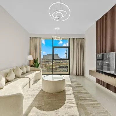 a living room with a white couch and a large window at 016 - Dubai Hills in Dubai