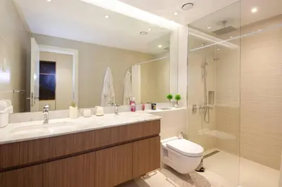 a bathroom with a sink and a toilet and a shower at 015 - Le Pont 1 in Dubai