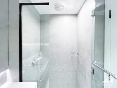 a bathroom with a glass shower and a sink at Studio Charm at Legacy Ideal Arjan Stay in Dubai