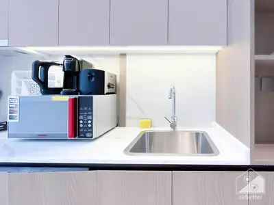 a kitchen counter with a sink and a microwave at Studio Charm at Legacy Ideal Arjan Stay in Dubai