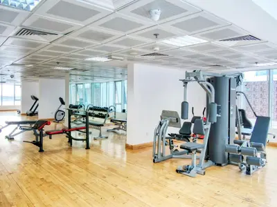 a gym with treadmills and exercise equipment in a building at Luxury Studio Apartment in JVC near Circle Mall in Dubai
