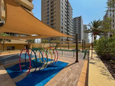 a playground with a slide in a pool at Frank Porter - Damac Ghalia in Dubai