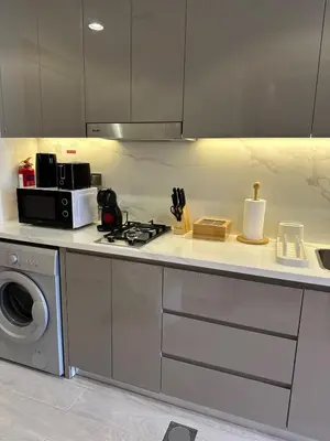 a kitchen with a stove and a microwave at Modern Studio Near Burj Khalifa in Dubai