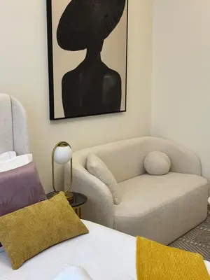 a living room with a couch and a chair at Modern Studio Near Burj Khalifa in Dubai