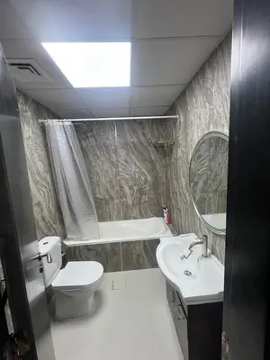 a bathroom with a sink and a toilet and a mirror at Dubai Marina Escan Tower Family Apartment in Dubai
