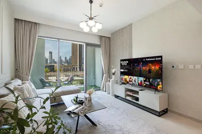 a living room with a flat screen tv at Beautiful 2BR - Burj Views And Dubai Mall Connection in Dubai