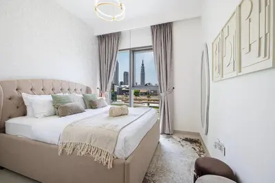 a bedroom with a large bed and a window at Beautiful 2BR - Burj Views And Dubai Mall Connection in Dubai
