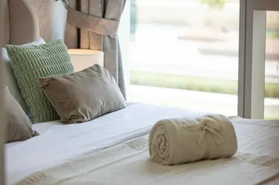 a white bed with a pillow and a window at Beautiful 2BR - Burj Views And Dubai Mall Connection in Dubai