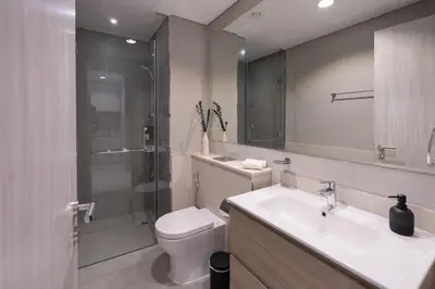 a bathroom with a toilet and a sink and a shower at Keyrock - Zada Tower, Business Bay Lake-View Apartment in Dubai