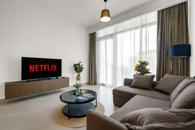 a living room with a couch and a tv at CanalFront - Central Location up to 7 Guests in Dubai